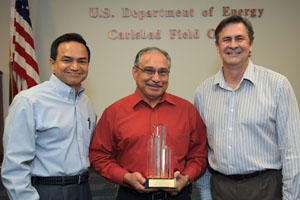 Department of Energy Carlsbad Field Site Operations Director Casey Gadbury (right) and Farok Sharif, President and Project Manager for Nuclear Waste Partnership LLC, the management and operating contractor at the Waste Isolation Pilot Plant, present the DOE's Voluntary Protection Program Legacy Star Award to Richard De Los Santos, protective force manager for Security Walls, the security contractor at the Waste Isolation Pilot Plant. The DOE-VPP legacy star award is the highest level of recognition possible in the VPP.
